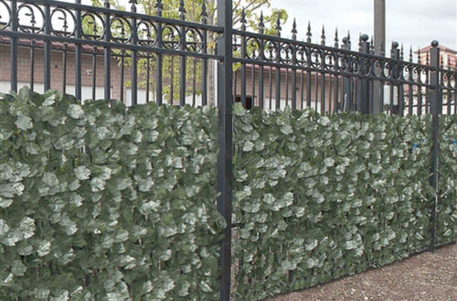 Steel fence with faux ivy fence screen