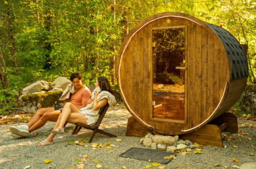 Sauna with two people sitting next to it.